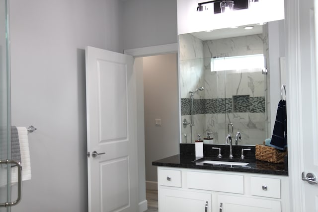 bathroom featuring vanity, hardwood / wood-style flooring, and a shower with shower door