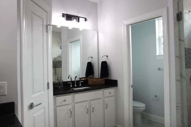 bathroom with vanity, toilet, and a shower with shower door