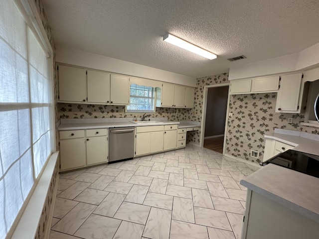 kitchen with sink, tasteful backsplash, dishwasher, and light tile floors