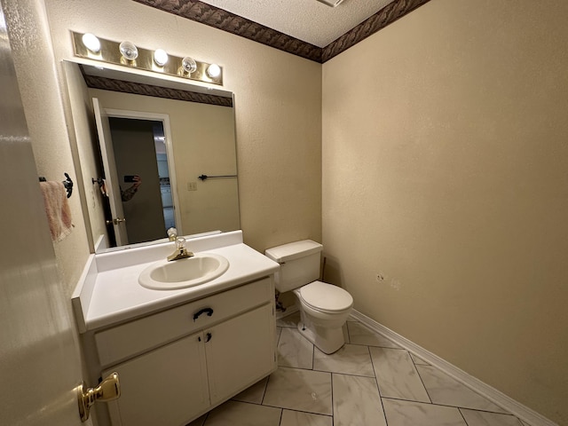 bathroom with tile flooring, vanity, toilet, and a textured ceiling