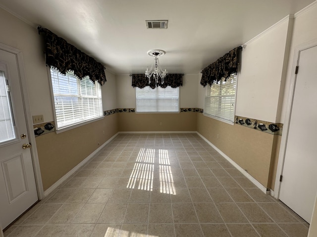 unfurnished dining area with plenty of natural light, an inviting chandelier, and light tile floors