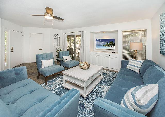 living room with ceiling fan and dark wood-type flooring