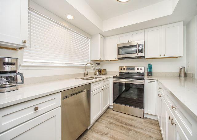 kitchen featuring white cabinets, sink, light hardwood / wood-style floors, and stainless steel appliances