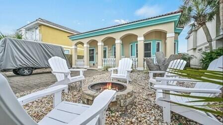 back of property featuring an outdoor fire pit