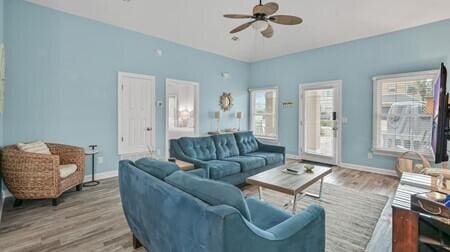 living room with ceiling fan and hardwood / wood-style floors