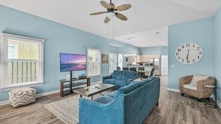 living room featuring ceiling fan and hardwood / wood-style floors