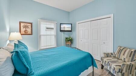 bedroom with hardwood / wood-style flooring and a closet