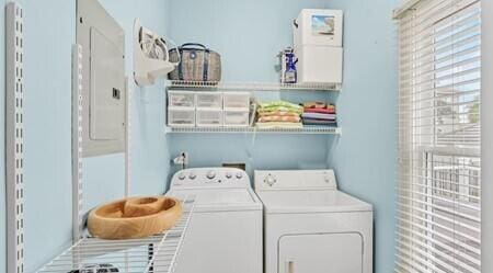 clothes washing area with independent washer and dryer