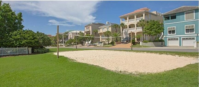 surrounding community featuring volleyball court and a lawn