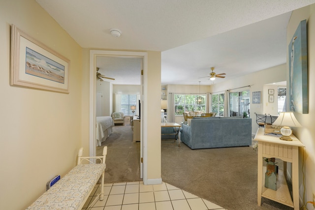 tiled living room featuring ceiling fan