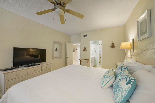 bedroom with connected bathroom, ceiling fan, and a textured ceiling