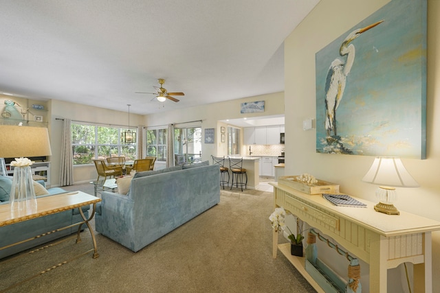 living room with carpet floors and ceiling fan