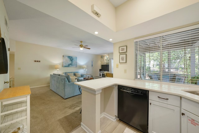 kitchen with black dishwasher, light carpet, white cabinets, kitchen peninsula, and ceiling fan