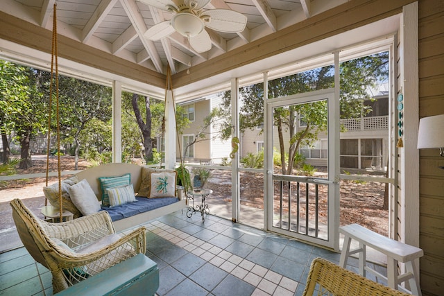 sunroom / solarium with lofted ceiling with beams and ceiling fan