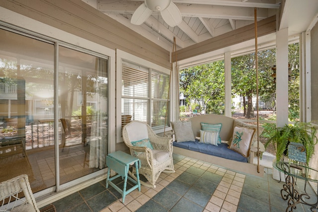 sunroom / solarium with ceiling fan and lofted ceiling with beams