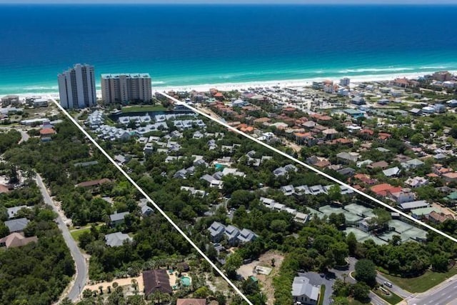 birds eye view of property featuring a water view and a beach view