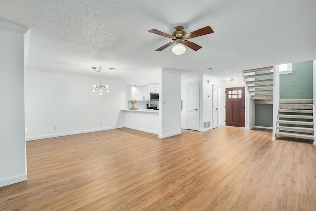 unfurnished living room with ceiling fan with notable chandelier, a textured ceiling, and light hardwood / wood-style floors