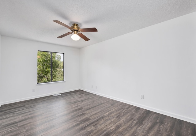 spare room featuring a textured ceiling, ceiling fan, and dark wood-type flooring