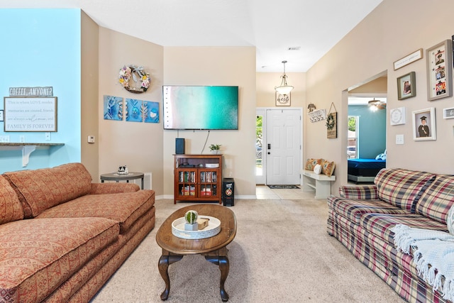 tiled living room with ceiling fan