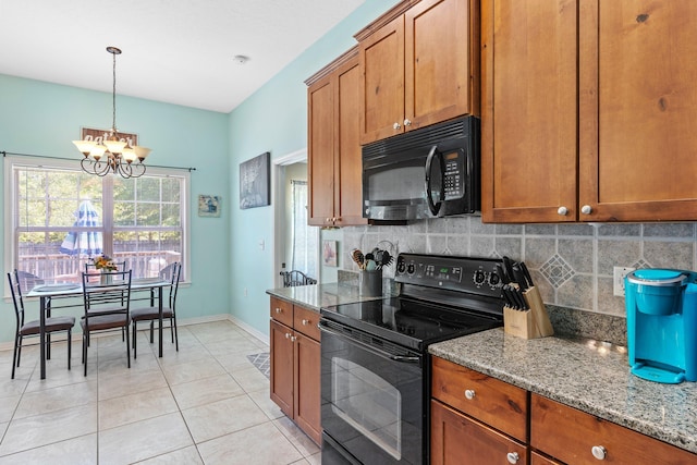 kitchen with decorative light fixtures, light stone countertops, black appliances, backsplash, and a chandelier