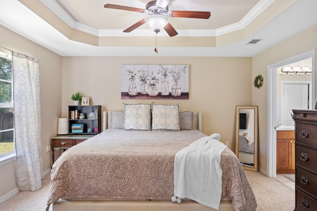 bedroom featuring ensuite bath, a raised ceiling, ceiling fan, and light colored carpet