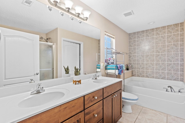 bathroom with vanity with extensive cabinet space, toilet, a bathing tub, double sink, and tile floors