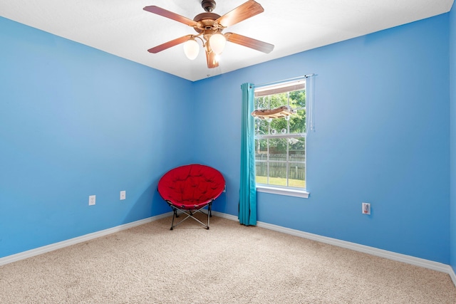 empty room featuring ceiling fan, carpet floors, and plenty of natural light