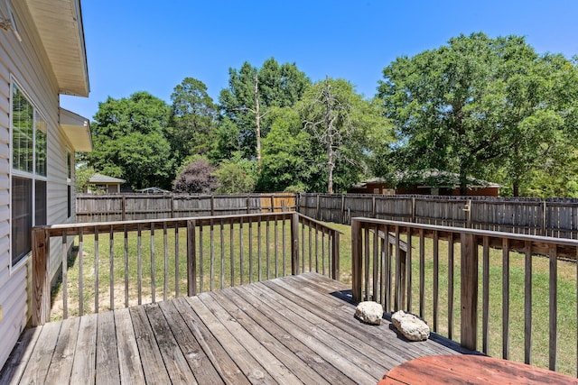 wooden terrace featuring a lawn