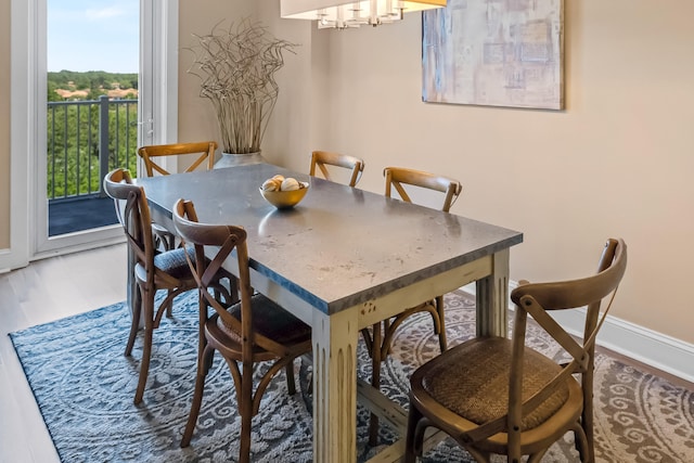 dining area featuring dark hardwood / wood-style flooring and an inviting chandelier