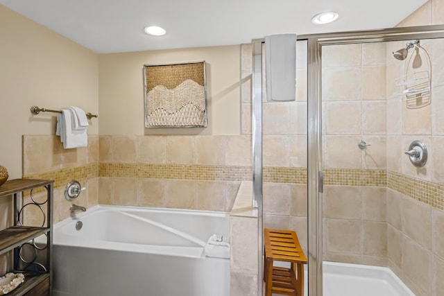 bathroom featuring shower with separate bathtub