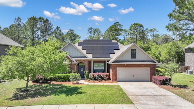 craftsman house featuring a garage, solar panels, and a front yard