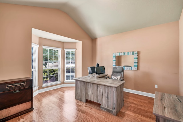 office area featuring light hardwood / wood-style floors and lofted ceiling