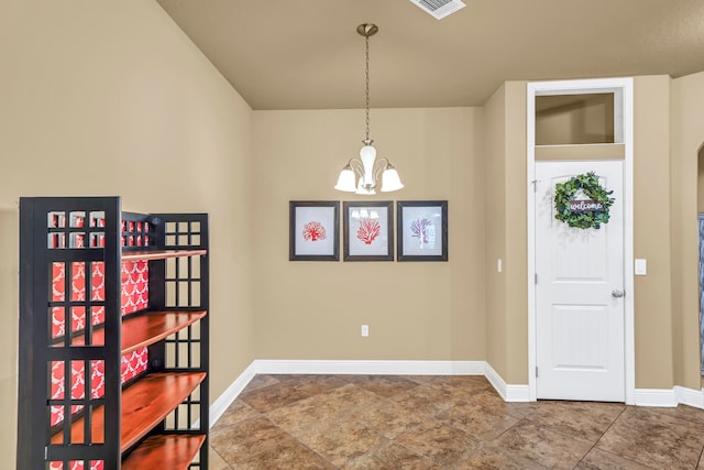 interior space featuring an inviting chandelier and tile flooring