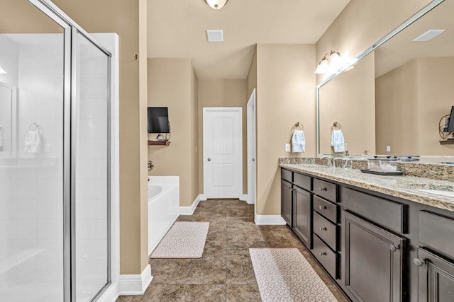 bathroom featuring tile floors, independent shower and bath, and double sink vanity