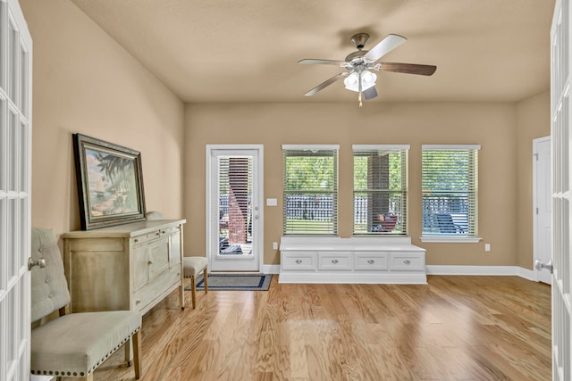 foyer featuring ceiling fan and light wood-type flooring