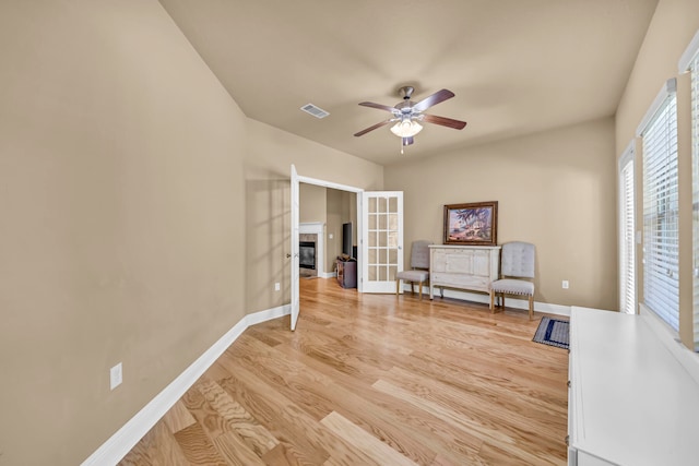 interior space with light hardwood / wood-style flooring and ceiling fan