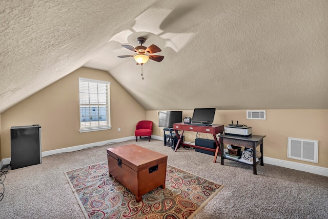 interior space featuring ceiling fan, carpet floors, and a textured ceiling