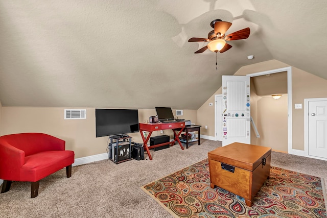 interior space with a textured ceiling, light carpet, ceiling fan, and vaulted ceiling