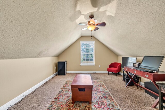 living area featuring light colored carpet, lofted ceiling, ceiling fan, and a textured ceiling