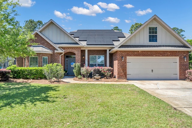 view of front of property with solar panels and a front lawn