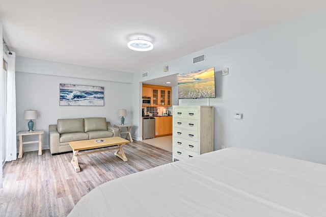 bedroom with light hardwood / wood-style floors