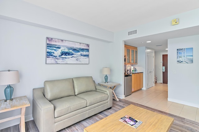 living room with sink and light tile floors