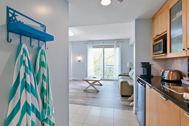 kitchen featuring light brown cabinetry, light tile floors, and stainless steel appliances