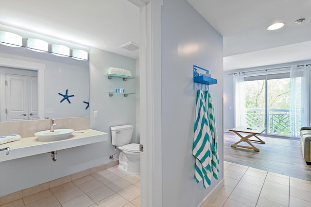 bathroom with tile flooring, vanity, and toilet