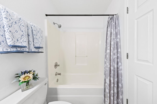 bathroom with shower / tub combo and toilet