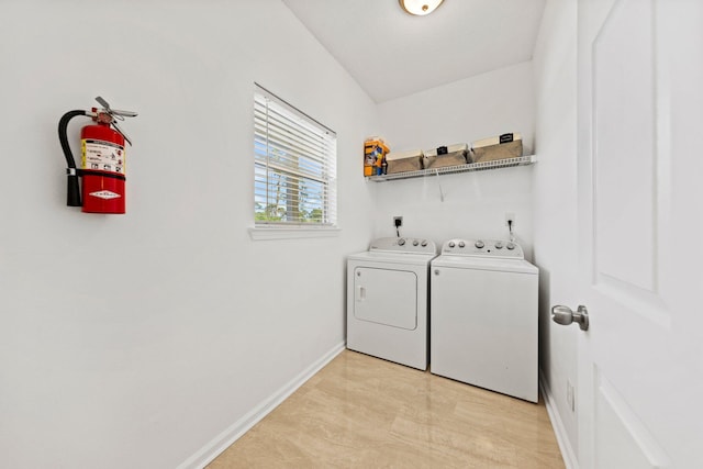 washroom featuring washer and dryer and light tile floors