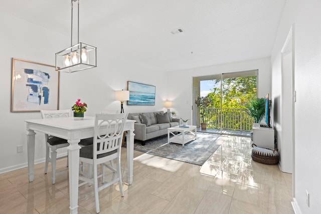 dining space with a chandelier