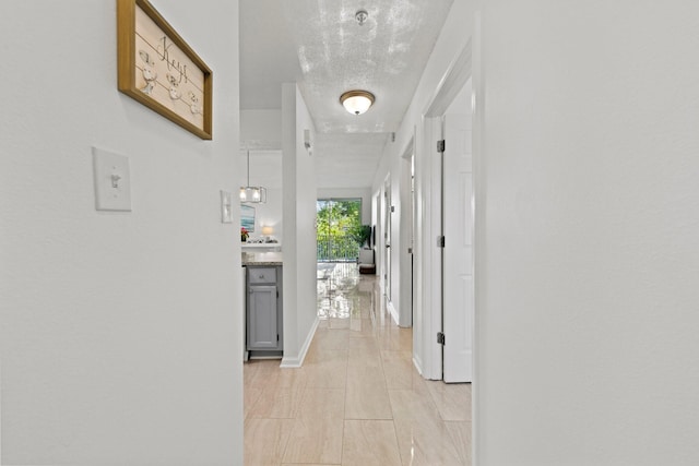 hallway featuring a textured ceiling