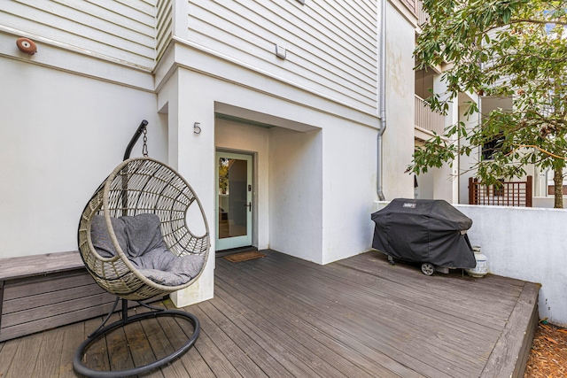 wooden terrace featuring a grill