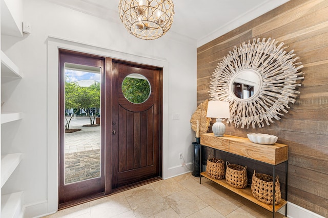 tiled foyer featuring crown molding